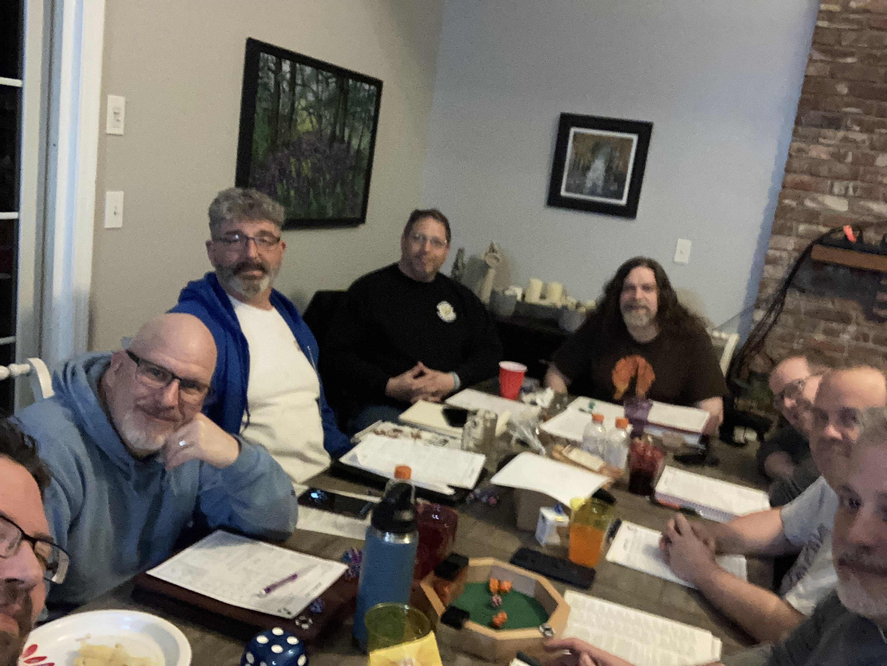 A table selfie of a bunch of old men playing around a table.